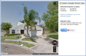 A google map of a house with trees in the background.